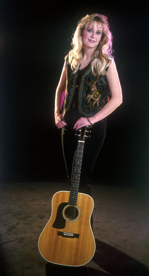 Carol Jean Cox photo; standing with guitar